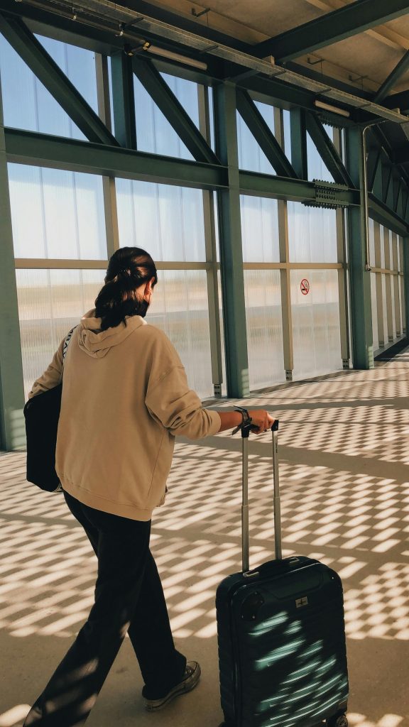 Solo traveler at the airport ready for a multi-week international journey.